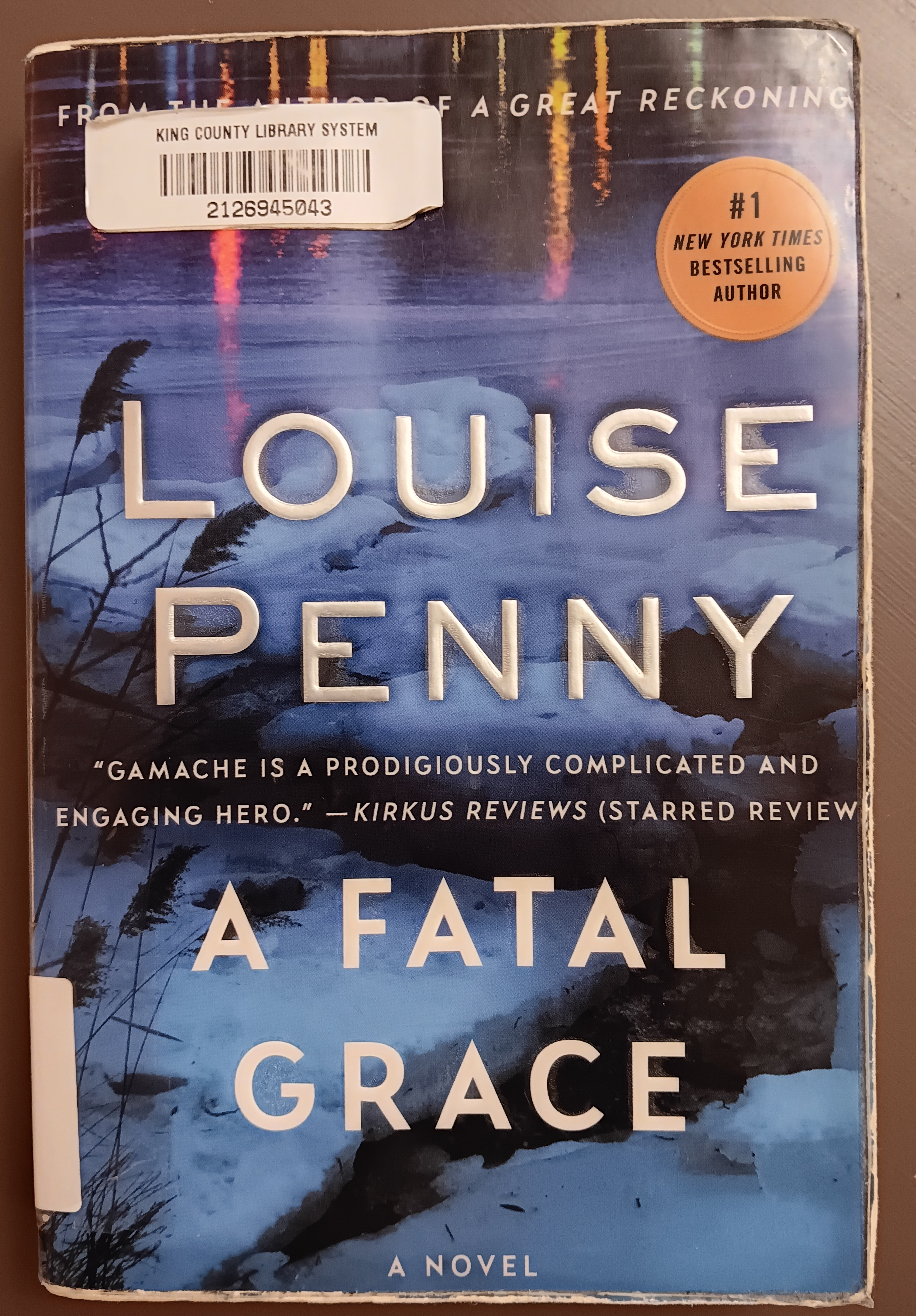 Cover of A Fatal Grace with a moody cracked icy lake